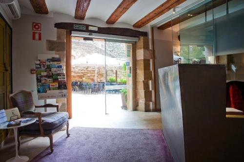 a living room with a door open to a patio at Hospederia Chapitel in Estella