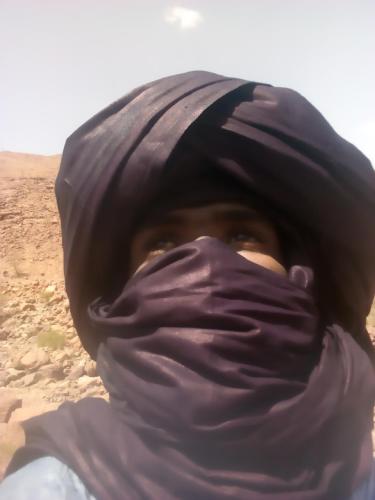 a person wearing a black scarf over their face at Bivouac Les Nomades & Foum zguid to chegaga tours in Foum Zguid