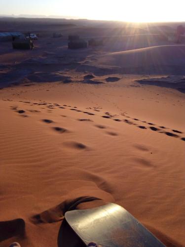 a view of a desert with footprints in the sand at Bivouac Les Nomades & Foum zguid to chegaga tours in Foum Zguid
