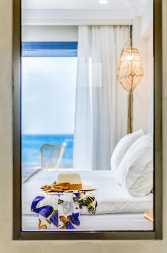 a bedroom with a bed with a view of the ocean at Pyrgos Blue in Malia