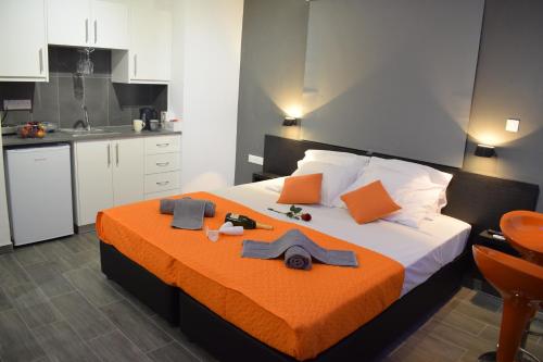 een slaapkamer met een groot bed en een oranje deken bij Takis apartments in Ayia Napa