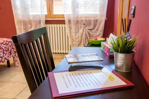 a desk with a keyboard and a book on it at Guest House Park in Valmontone