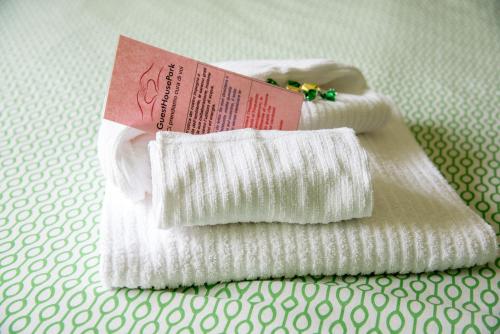 two white towels with a packet on top of them at Guest House Park in Valmontone