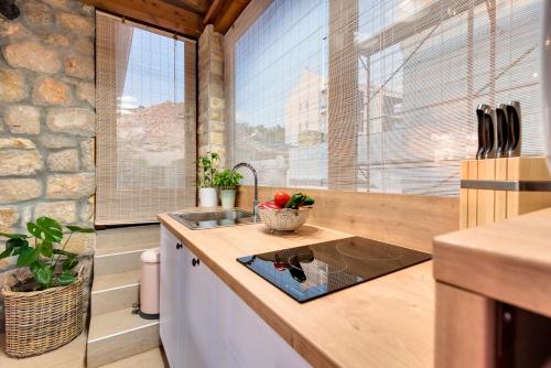 a kitchen with a sink and a large window at Sun gardens in Šibenik