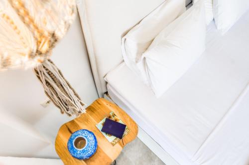 a wooden tray sitting next to a bed at Pyrgos Blue in Malia