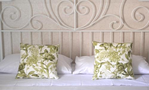 a bed with two pillows and a headboard at Casa Jolanda B&B in Palermo