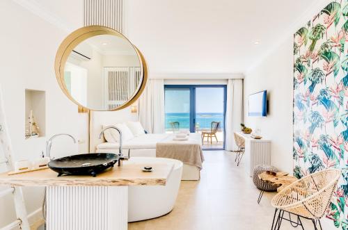 a living room with a large mirror and a tub at Pyrgos Blue in Malia