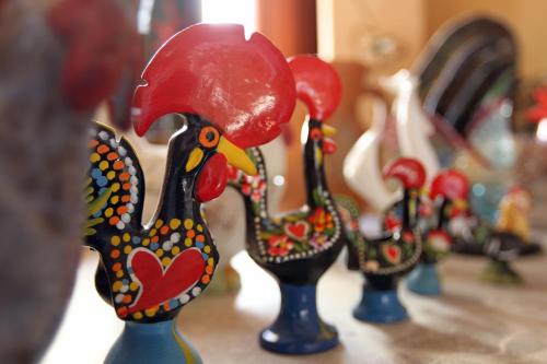a row of colorful vases with a red cap on them at Heritage Hotel Kukuriku in Kastav