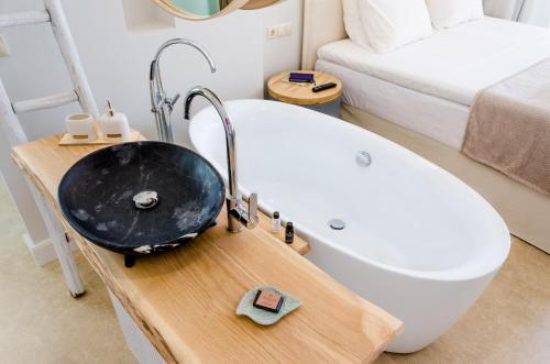 a bathroom with a sink and a bath tub at Pyrgos Blue in Malia
