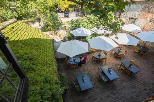 an overhead view of a patio with tables and umbrellas at Saltmarsh Farmhouse in West Dean