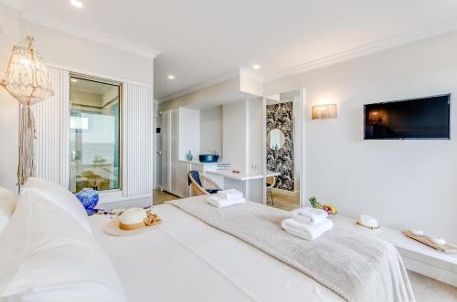 a white living room with a large white bed at Pyrgos Blue in Malia