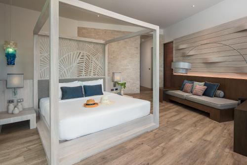 a bedroom with a large white bed and a couch at Idyllic Concept Resort in Ko Lipe