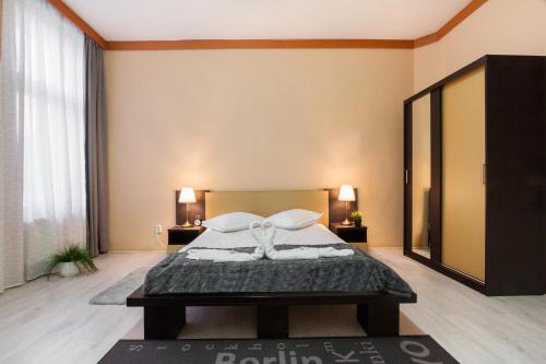 a bedroom with a bed and a large mirror at Szilagyi Hotel&Restaurant in Gheorgheni