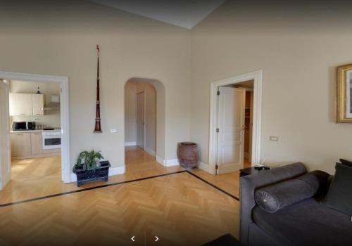 a living room with a couch and a kitchen at Casa Rubinacci in Naples