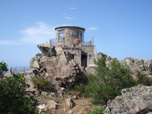 an old house on the side of a mountain at Appartamento MareMontagna in Cardedu