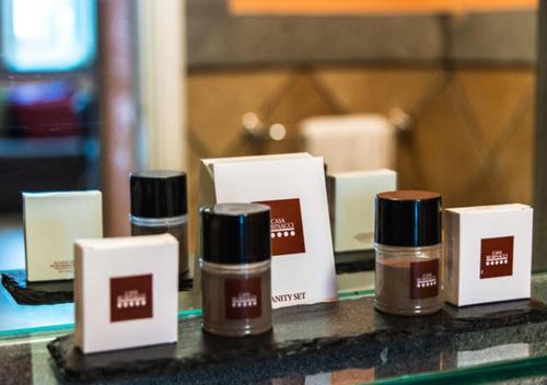 a group of four bottles of hair products on a counter at Casa Rubinacci in Naples