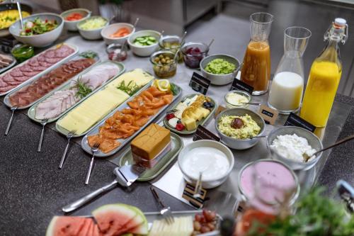 a table topped with lots of different types of food at Ydalir Hotel in Stavanger