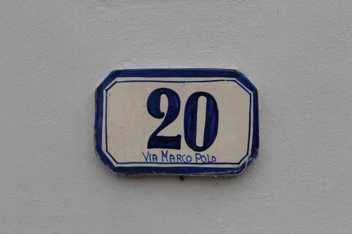 a blue and white sign on a wall at Hotel Ambra in Forte dei Marmi