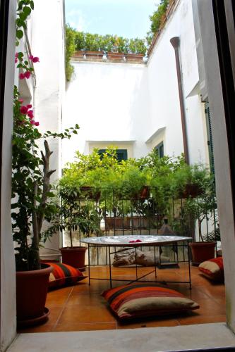a balcony with a table and potted plants at Buon Consiglio B&B in Lecce