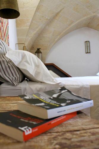 a book sitting on the floor next to a bed at Buon Consiglio B&B in Lecce