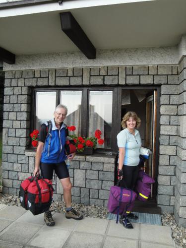 two people standing in front of a building with their luggage at Pension Apartment Granit in Prague