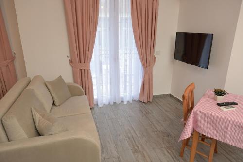 a living room with a couch and a table at Brothers Cesme Hotel in Cesme