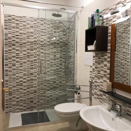 a bathroom with a shower and a toilet and a sink at B&B Mariupol in Trapani