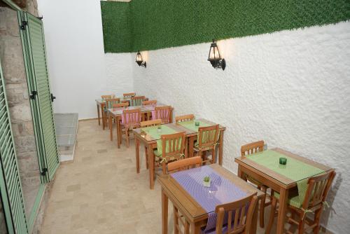 a row of tables and chairs in a restaurant at Brothers Cesme Hotel in Cesme