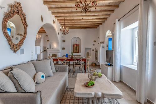 a living room with a couch and a table at Blue Serenity Villa in Fanari