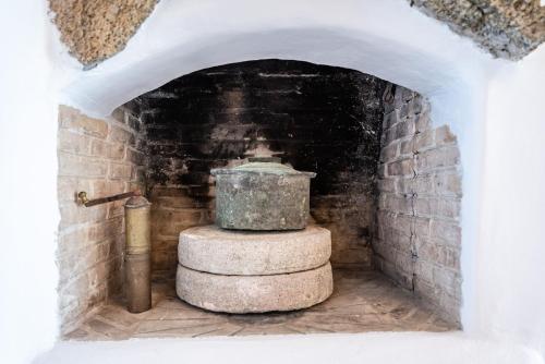 a stone fountain in a brick arch way at Blue Serenity Villa in Fanari
