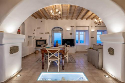 a kitchen and living room with a table and chairs at Blue Serenity Villa in Fanari