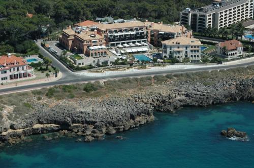 an aerial view of a resort next to the ocean at Grande Real Villa Itália Hotel & Spa in Cascais