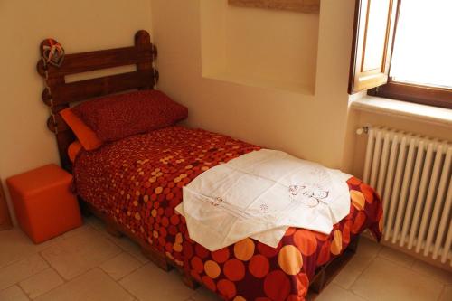una piccola camera con un letto in una stanza di La Suite nel Bosco a Selva di Fasano