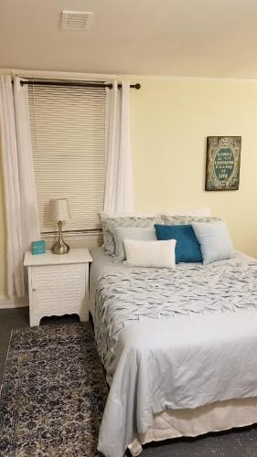 a bedroom with a bed and a night stand with a lamp at Relaxing, Comfortable, Private Bedroom in Atlanta