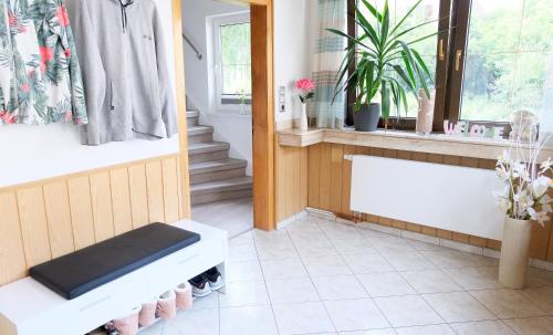 a bathroom with a white bench and a window at Heimathafen Weimar in Weimar
