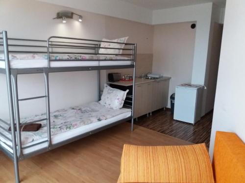 a room with two bunk beds and a desk at Family Hotel Casablanca Green in Varna City