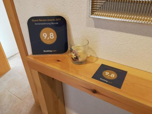 a glass on a table with a sign on it at Ferienwohnung Moralé in Seefeld in Tirol