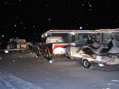 a truck parked next to a trailer in the snow at Valley Inn Motel in Sudbury