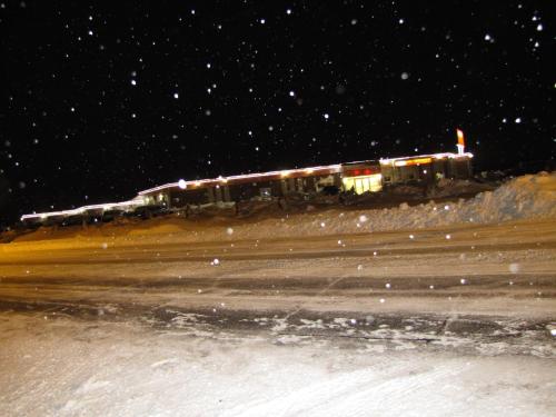 a train on a track in the snow at night at Valley Inn Motel in Sudbury