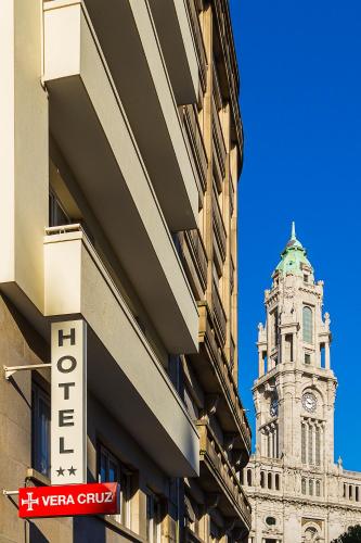 a tall building with a clock tower in the background at Vera Cruz Porto Downtown Hotel in Porto