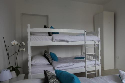 a room with two bunk beds with pillows at Apartment Nijona in Trebinje