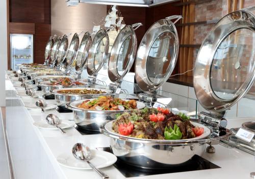 a row of plates of food in a buffet at Novotel Jazan in Jazan