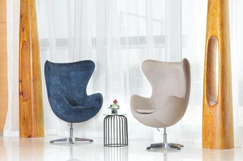 a couple of chairs sitting next to a window at Novotel Jazan in Jazan