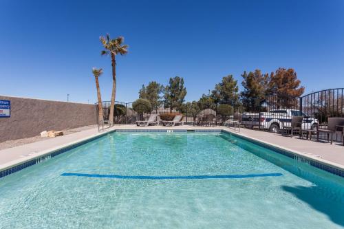 a large swimming pool with blue water at Baymont by Wyndham Barstow Historic Route 66 in Barstow