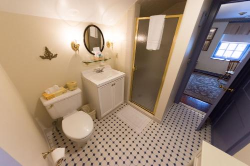 a small bathroom with a toilet and a shower at Thomas Bond House in Philadelphia