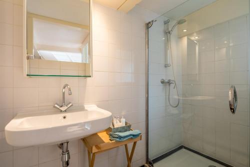 a bathroom with a sink and a shower at Casa Nora in Alkmaar