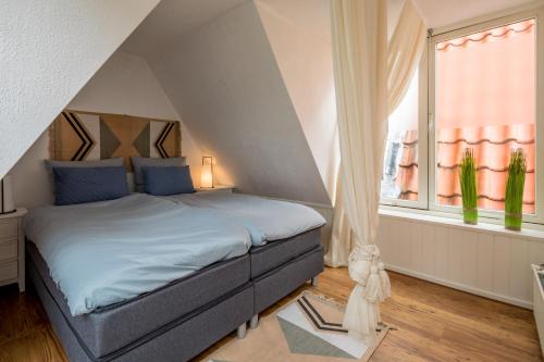 a bedroom with a bed and a large window at Casa Nora in Alkmaar