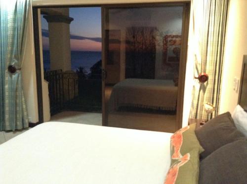 a bedroom with a bed and a view of the ocean at Oceanica Resort Flamingo in Playa Flamingo