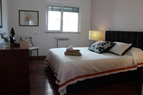 a bedroom with a bed with two pillows on it at Great Apartment in Meo Arena and Fil in Lisbon