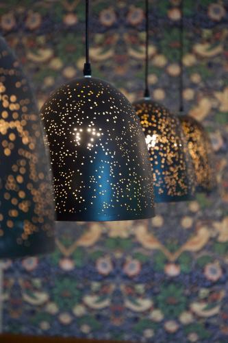 a group of lights hanging from a ceiling at Chez Bure - Bure Homestay in Kanchanaburi